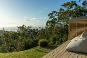 Cozy outdoor porch and seating deck with scenic coastal views at Views Over Wilderness luxury holiday accommodation.