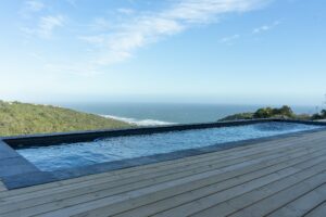 Sparkling swimming pool and wooden sun deck at Views Over Wilderness luxury holiday accommodation along the Garden Route.